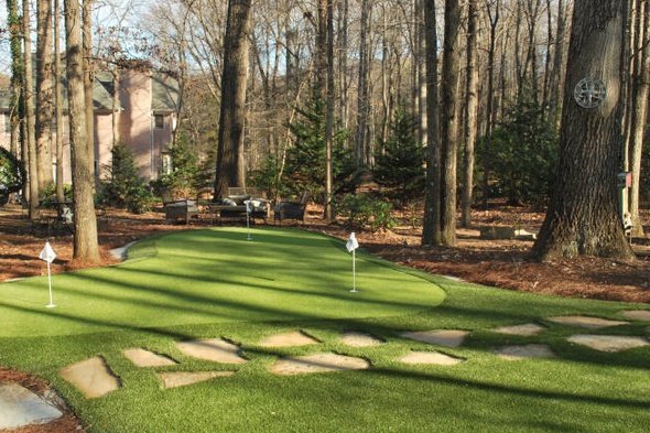 Huntsville backyard putting green with flags and trees